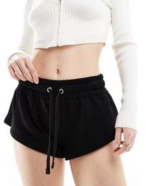 Oferta de Pantalones muy cortos negros de punto liso de ASOS DESIGN por 22,99€ en Asos
