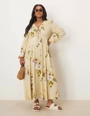 Oferta de Vestido midi de manga larga con cuello de pico, estampado floral y lazada delantera de ASOS DESIGN Curve por 52,99€ en Asos